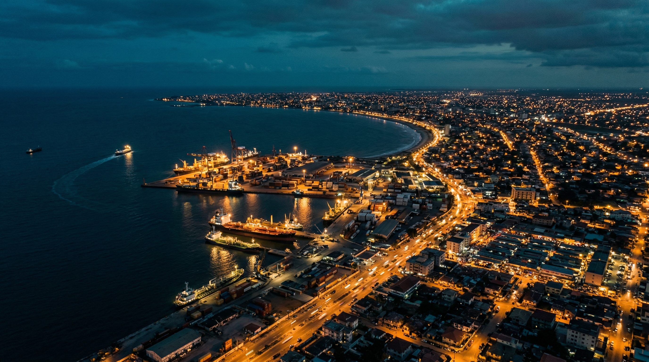 Aerial view of an African coastal port city at twilight